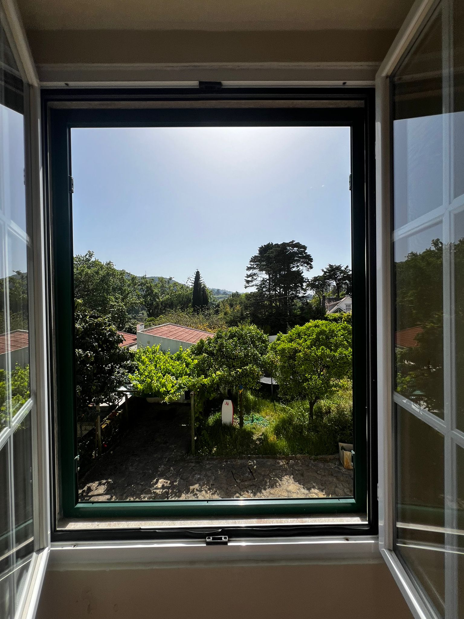 Garden and Sintra hills seen through an open window