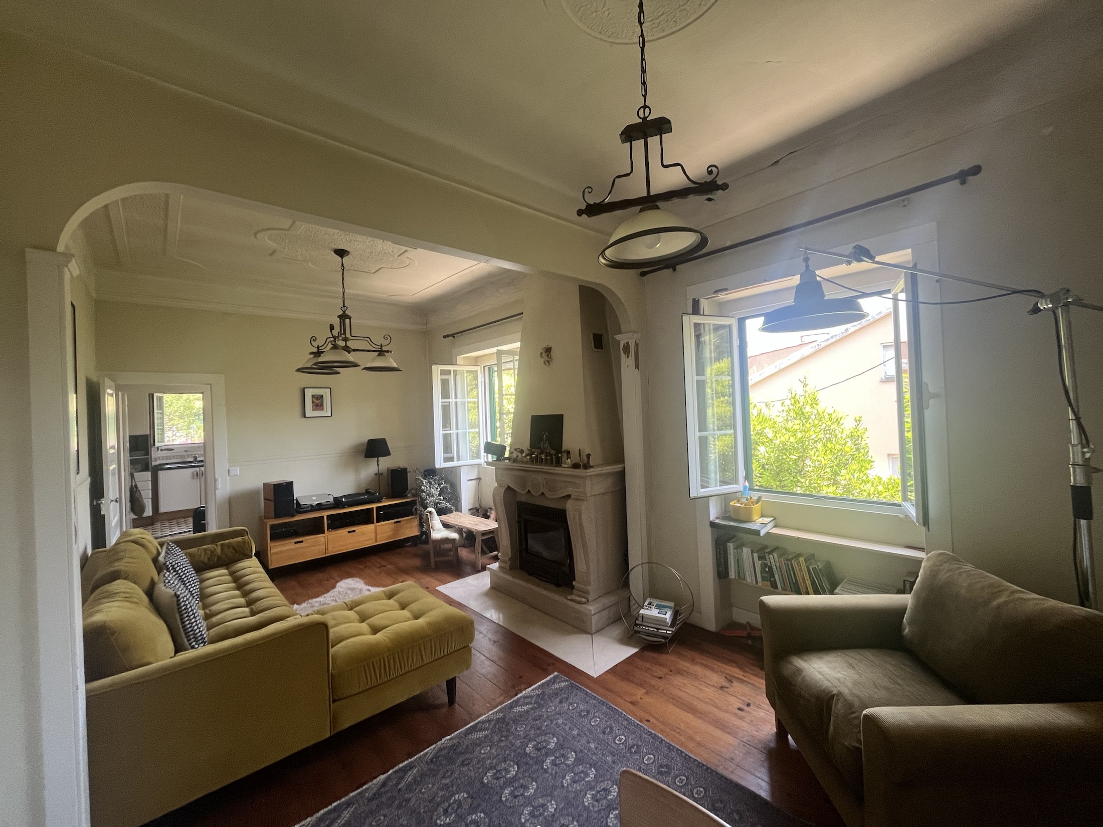 Living room with high ceilings, open windows and old-house character